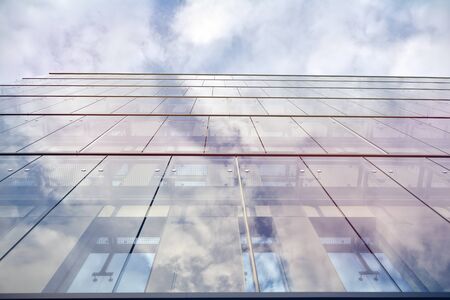Sky reflected in a modern building glass facade