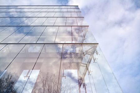 Sky reflected in a modern building glass facade