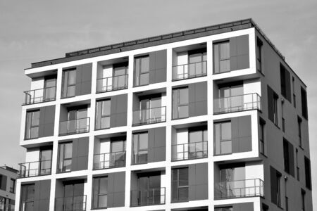 Detail of modern residential flat apartment building exterior. Fragment of new luxury house and home complex. Black and white.の写真素材