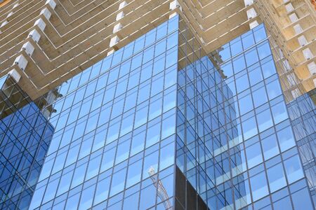 New modern office skyscraper being built in a city. Architectural facade building during...