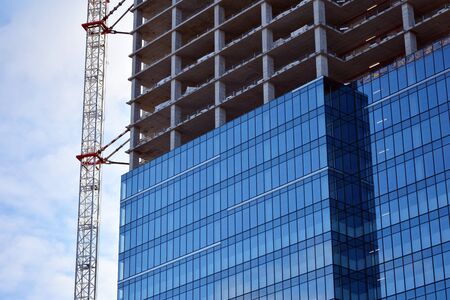 New modern office skyscraper being built in a city. Architectural facade building during...
