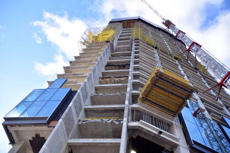 New modern office skyscraper being built in a city. Architectural facade building during...