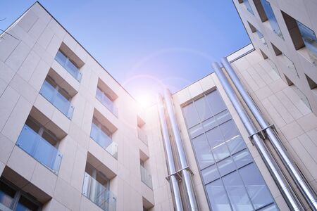 Modern apartment buildings on a sunny day with a blue sky. Facade of a modern apartment building....