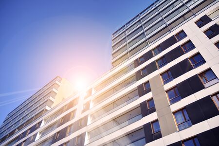 Sun rays light effects on urban buildings. Fragment of modern residential apartment with flat...