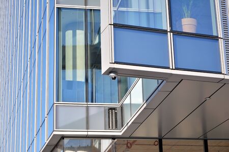 Abstract image of looking up at modern glass and concrete building. Architectural exterior detail of...