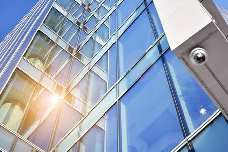 Abstract image of looking up at modern glass and concrete building. Architectural exterior detail of...