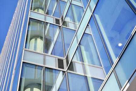 Abstract image of looking up at modern glass and concrete building. Architectural exterior detail of...