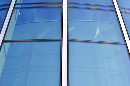 Abstract image of looking up at modern glass and concrete building. Architectural exterior detail of...