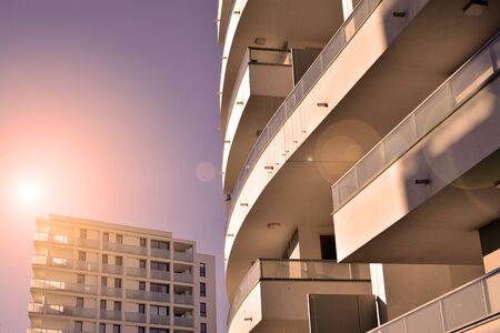 Sun rays light effects on urban buildings. Fragment of modern residential apartment with flat...