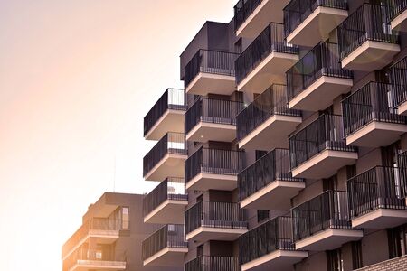 Sun rays light effects on urban buildings. Fragment of modern residential apartment with flat...