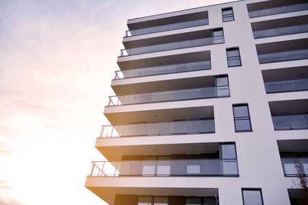 Sun rays light effects on urban buildings. Fragment of modern residential apartment with flat buildings exterior. Detail of new luxury house and home complex.の写真素材