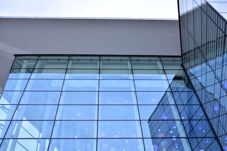 Abstract image of looking up at modern glass and concrete building. Architectural exterior detail of...