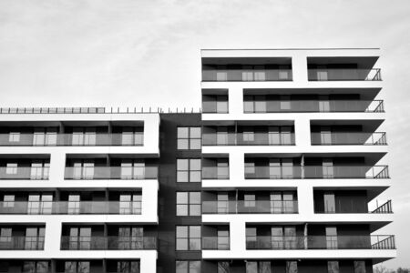 Sun rays light effects on urban buildings. Fragment of modern residential apartment with flat buildings exterior. Detail of new luxury house and home complex. Black and white.の写真素材