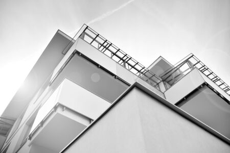 Sun rays light effects on urban buildings. Fragment of modern residential apartment with flat buildings exterior. Detail of new luxury house and home complex. Black and white.の写真素材