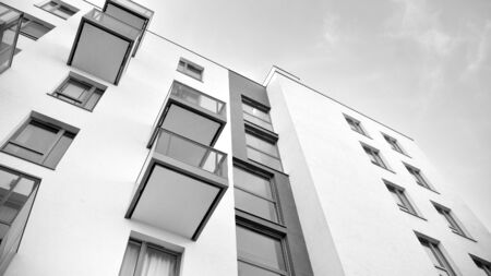 Sun rays light effects on urban buildings. Fragment of modern residential apartment with flat buildings exterior. Detail of new luxury house and home complex. Black and white.の写真素材
