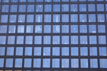 Abstract reflection of modern city glass facades. Modern office building detail, glass surface.の写真素材