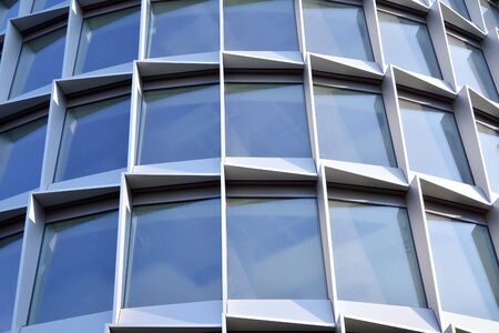 Abstract reflection of modern city glass facades. Modern office building detail, glass surface.
