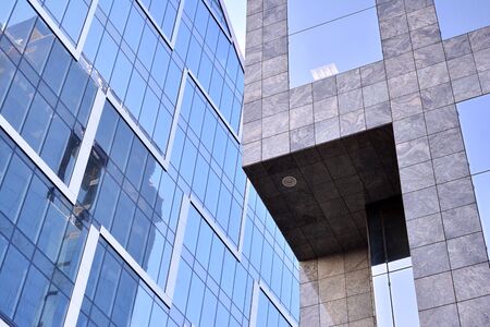 Abstract reflection of modern city glass facades. Modern office building detail, glass surface.