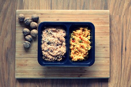 Risotto with vegetables on a wooden table close up.