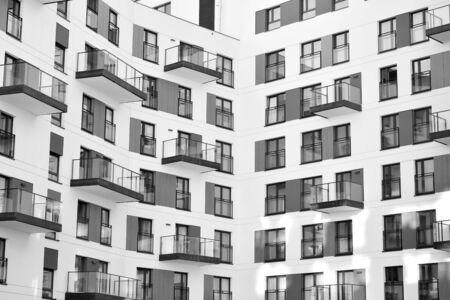 Detail of modern residential flat apartment building exterior. Fragment of new luxury house and home complex. Black and white.の写真素材