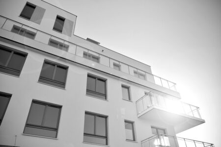 Detail of modern residential flat apartment building exterior. Fragment of new luxury house and home complex. Black and white.の写真素材