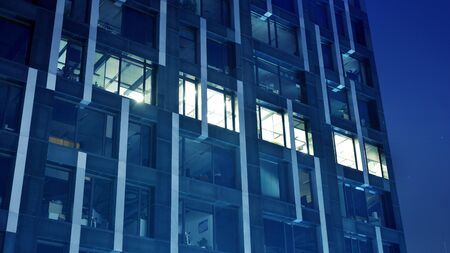 Night architecture - building with glass facade. Modern building in business district. Concept of...