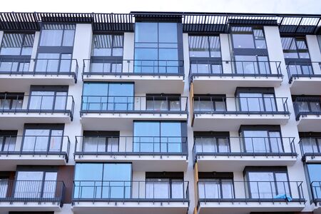 Construction of new city apartment building. Residential building under construction against blue...