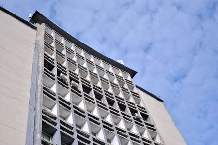 Facade of an old industrial office building with a predominance of old cement and old structural...
