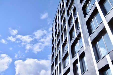 Modern office building facade abstract fragment, shiny windows in steel structure