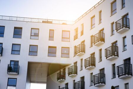 Modern apartment building flat estate concept. Outdoor residential facility at sunset and sunrise.