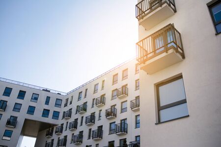 Modern apartment building flat estate concept. Outdoor residential facility at sunset and sunrise.の写真素材
