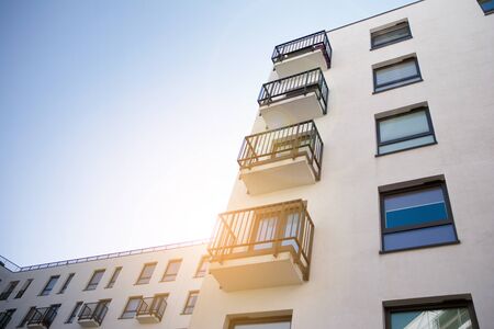 Modern apartment building flat estate concept. Outdoor residential facility at sunset and sunrise.