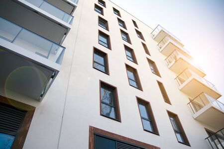 Modern apartment building flat estate concept. Outdoor residential facility at sunset and sunrise.