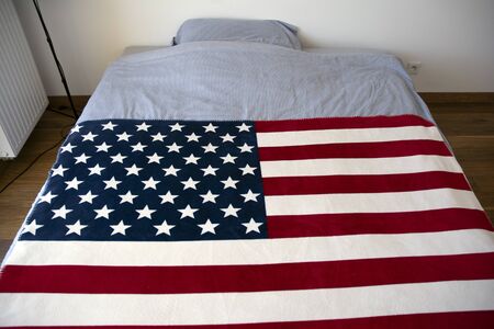 Above view of USA United States of American flag in bedroom with light interior. Happy Flag Day conceptの写真素材