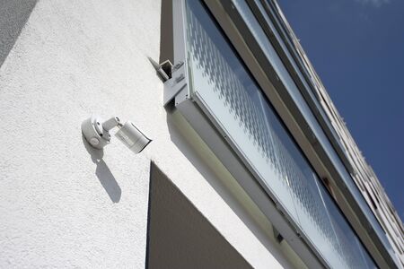 Outdoor CCTV camera external video surveillance system on the facade of a residential building.