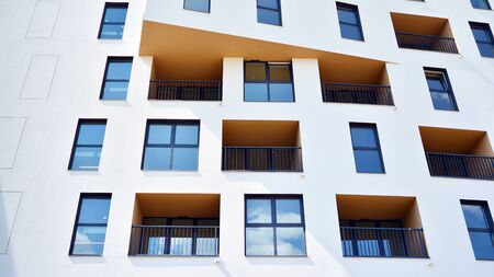 Contemporary residential building exterior in the daylight. Modern apartment buildings on a sunny day with a blue sky. Facade of a modern apartment buildingの写真素材