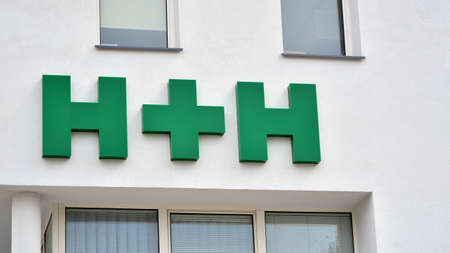 Warsaw, Poland. 2 May 2020. Sign H + H. Company signboard H + H.のeditorial素材