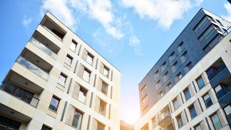 Modern apartment buildings on a sunny day with a blue sky. Facade of a modern apartment building....