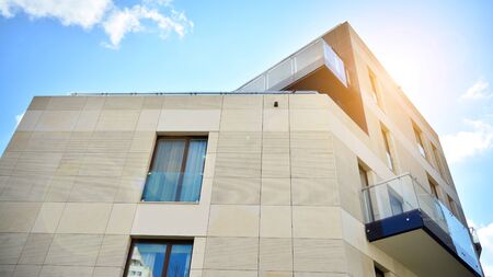 Modern apartment buildings on a sunny day with a blue sky. Facade of a modern apartment building....