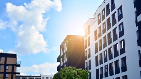 Modern apartment buildings on a sunny day with a blue sky. Facade of a modern apartment building....