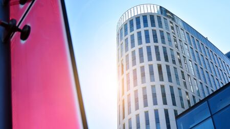 Bottom view of office building window close up with sunrise, reflection and perspective. Modern...