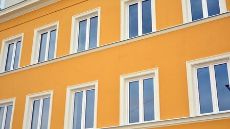 Beautiful yellow facade, restored building exterior in old town.