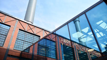 Structural glass wall reflecting blue sky. Abstract modern architecture fragment. View of a modern...