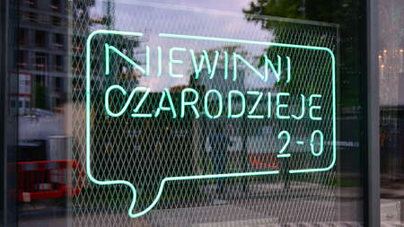 Warsaw, Poland. 25 May 2020. Sign Niewinni Czarodzieje 2-0 / Innocent Wizards 2-0. Company signboard Niewinni Czarodzieje 2-0 / Innocent Wizards 2-0.のeditorial素材