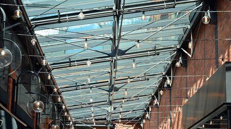 Glass ceiling with lamps in revitalized building.