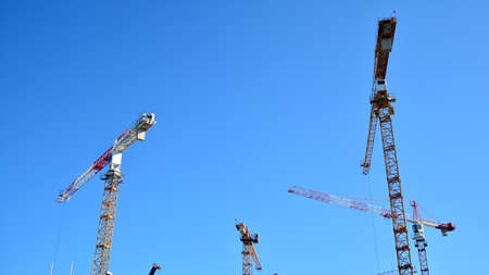 Warsaw, Poland. June 2, 2020. Crane and building under construction against blue sky. Artistic Zoliborz.のeditorial素材