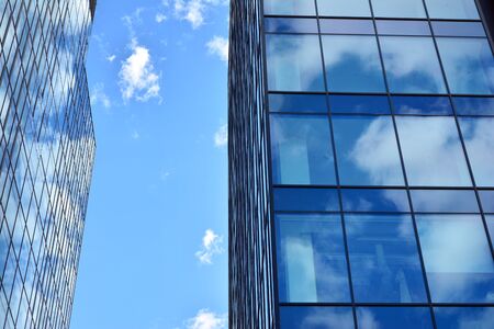 Facade texture of a glass mirrored office building. Fragment of the facade. Modern architecture of...