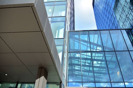 Facade texture of a glass mirrored office building. Fragment of the facade. Modern architecture of...