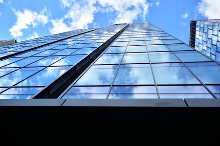 Facade texture of a glass mirrored office building. Fragment of the facade. Modern architecture of...