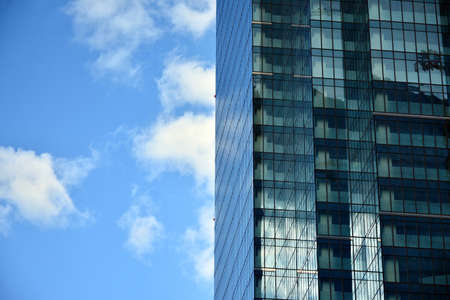 Facade texture of a glass mirrored office building. Fragment of the facade. Modern architecture of the office building.のeditorial素材